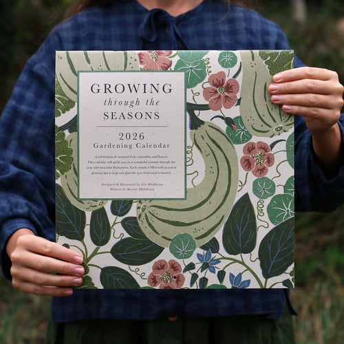 Person holding a 2026 gardening calendar with floral and leaf design