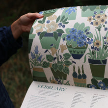 Load image into Gallery viewer, Person holding a 2026 gardening calendar with a floral and plant pattern, focusing on the page titled &#39;February&#39;.
