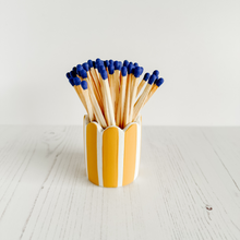 Load image into Gallery viewer, Hand cast and hand painted match striker with yellow stripes and blue match sticks