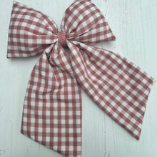 Load image into Gallery viewer, Pink and white gingham bow on a light wooden surface