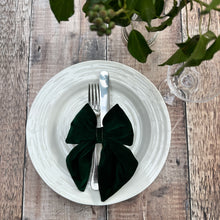 Load image into Gallery viewer, A handmade green velvet bow on a place setting for Christmas with ivy and champagne glass