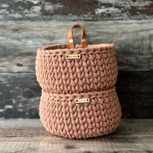 A pair of stacked handmade mini baskets in recycled cotton cord in a blush pink colour