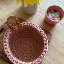 Load image into Gallery viewer, A mini classic basket in blush pink on a wooden table with a vase of daffodils and a handmade pink bowl full of mini eggs