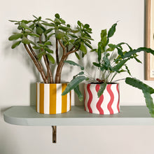 Load image into Gallery viewer, Large plant pot on coral squiggles next to a yellow striped plant pot