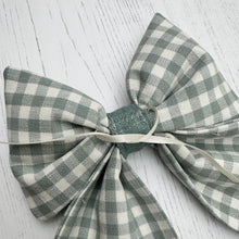 Load image into Gallery viewer, Green and white gingham bow on a light wooden surface