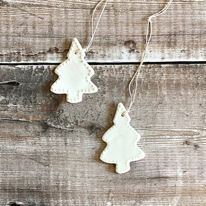 A duo of handmade porcelain Christmas trees