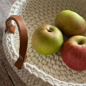 Close up detail of the leather strap in the handmade crochet basket