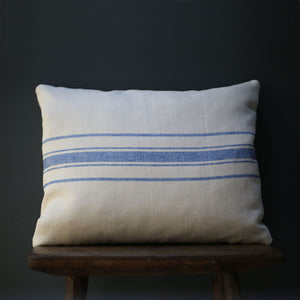 Handmade Peony & Sage Cushion in Danish Blue Stripe shown on a stool