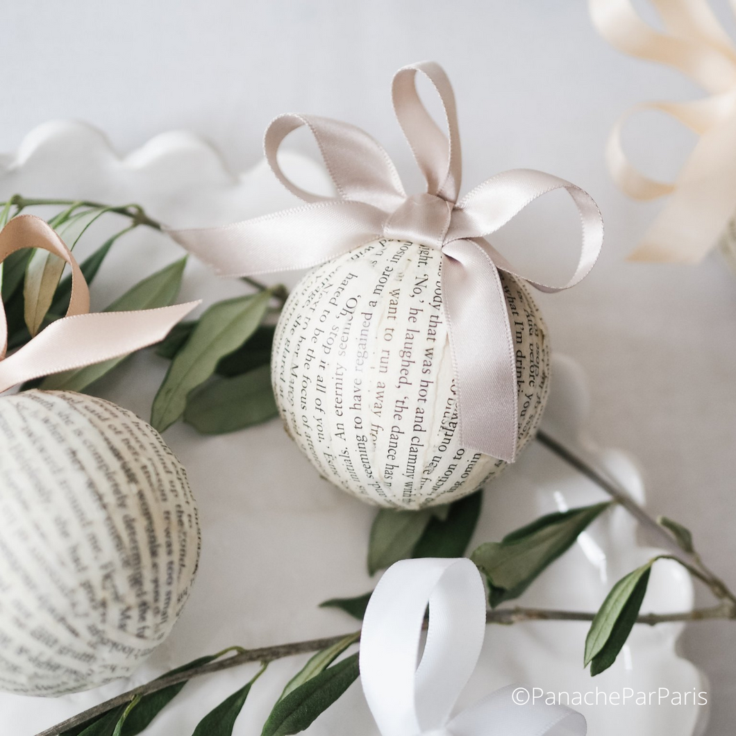 Handmade Bauble made from folded book paper.  Complete with a satin ribbon in griege