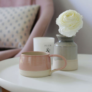 Rhubarb & Hare's Handmade Pink Mug alongside the grey vase, Plum & Ashby Candle and Olive & Daisy cushion