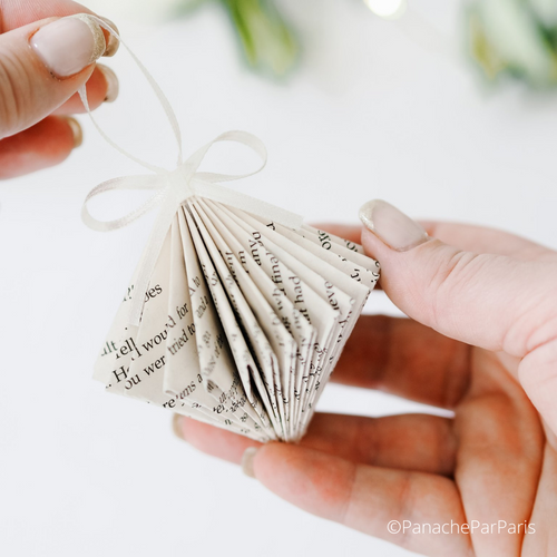 The beautiful handmade paper diamond decoration complete with a thin white ribbon 