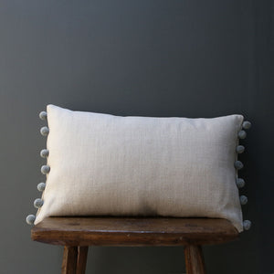 Handmade by Catkin & Olive these cushions are in Peony & Sage's chunky linen in natural with pom poms in Natural Fog.   A pair would sit beautifully on your bed, or a single one would look lovely on an armchair.  