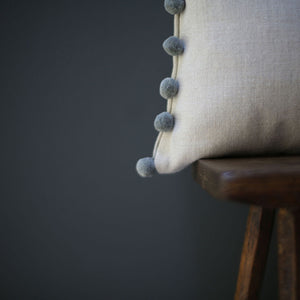 Handmade by Catkin & Olive these cushions are in Peony & Sage's chunky linen in natural with pom poms in Natural Fog.   A pair would sit beautifully on your bed, or a single one would look lovely on an armchair.  