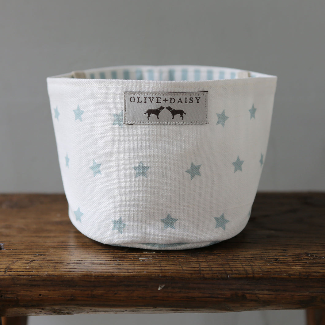 Perfect for a nursery or little one's room, this is a great size for a versatile storage tidy.    Handmade by Olive & Daisy in their Lincolnshire workroom on vintage industrial sewing machines using their gorgeous blue Shooting Stars linen fabric, designed and printed all in the UK.