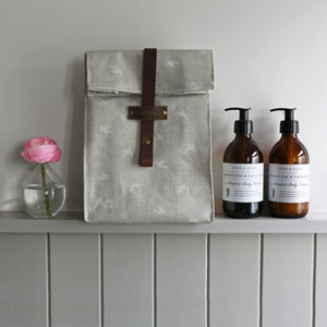 Handmade wash bag with a chocolate leather strap and Olive & Daisy fabric