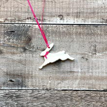 Load image into Gallery viewer, a handmade ceramic running hare easter decoration with satin pink ribbon